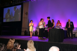 Megan Turner accepts her framed certificate.